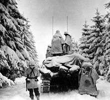 504th Regiment, 82nd Airborne troops advancing through snow covered 