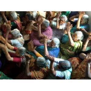 Abandoned Elderly Women Raise Hands During a Prayer Meeting Premium 