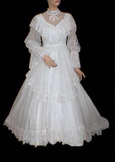 This 70s wedding dress features a shawl collar and poet sleeves, in a 