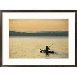  A kayaker paddles across Lake Sebagos calm waters in low 