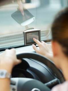 Woman touching Garmin GPS screen in her car