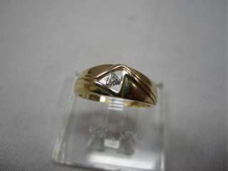 One 14k yellow gold ring with trilliant cut Diamond. Diamond is 