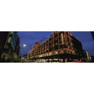  Buildings Lit Up at Night, Harrods, London, England by 