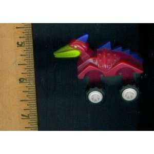 Wind up Toy. Pink Dragon with Blue Armor and Green Face. Wheels That 